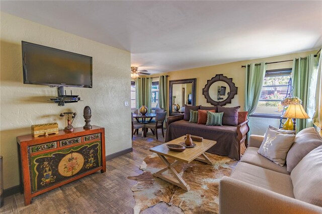 living room featuring dark hardwood / wood-style floors and ceiling fan