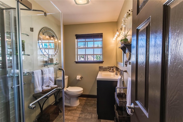 bathroom featuring vanity, toilet, an enclosed shower, and hardwood / wood-style floors