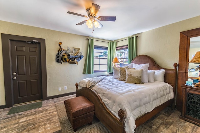 bedroom featuring dark wood-type flooring and ceiling fan