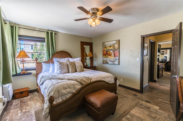 bedroom featuring ceiling fan and dark hardwood / wood-style floors