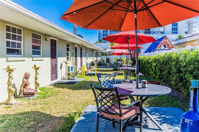 600 Oakridge Blvd, Daytona Beach, FL 32118 - fenced backyard featuring outdoor dining space and a patio area