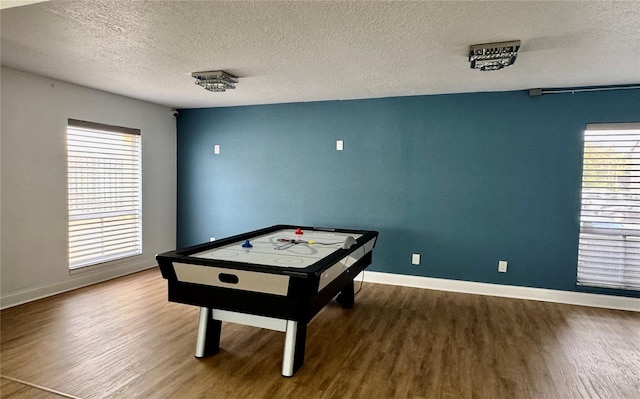 rec room with a textured ceiling and wood-type flooring