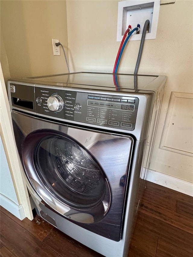 clothes washing area featuring washer / dryer and dark hardwood / wood-style floors