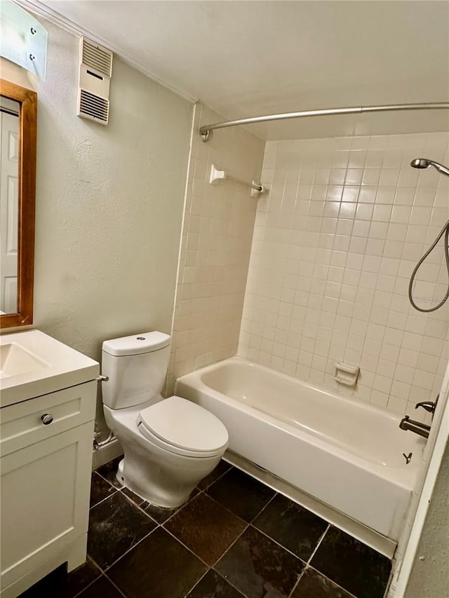 full bathroom with vanity, tiled shower / bath combo, toilet, and tile patterned floors