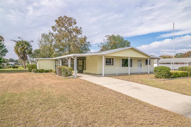 ranch-style home with a carport and a front yard