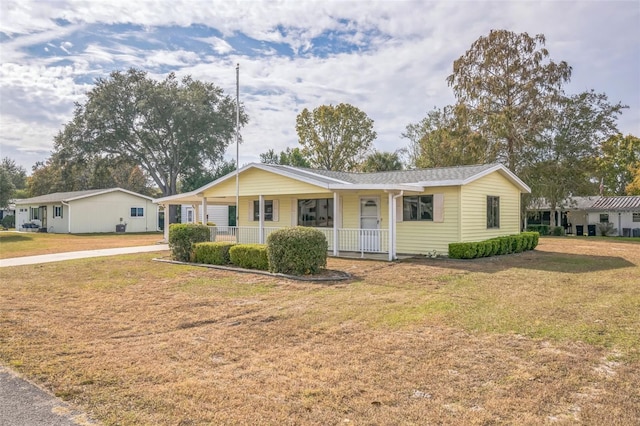 single story home featuring a front lawn and a porch