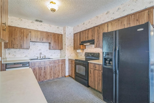 kitchen featuring carpet flooring, sink, black appliances, and a textured ceiling