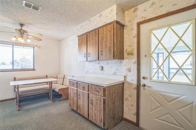 10170 SW 96th Ct, Ocala, FL 34481 - kitchen with wallpapered walls, carpet floors, a textured ceiling, healthy amount of natural light, and baseboards
