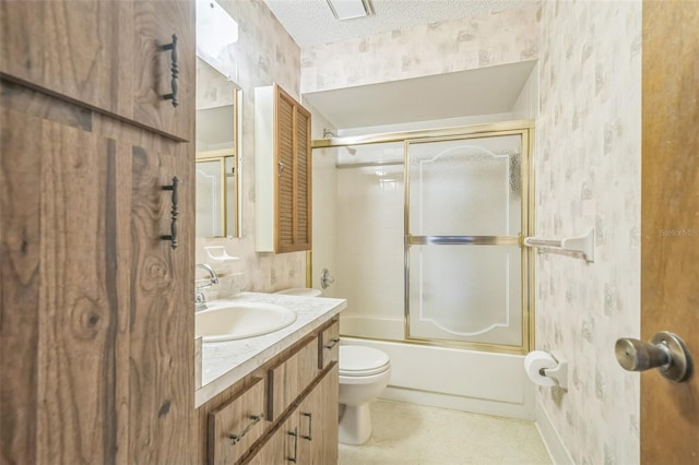 full bathroom with a textured ceiling, vanity, toilet, and bath / shower combo with glass door