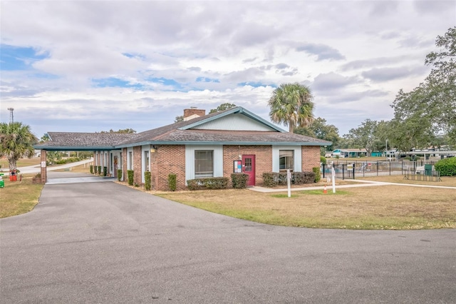 10170 SW 96th Ct, Ocala, FL 34481 - view of front of house featuring brick siding, a chimney, and asphalt driveway