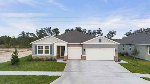 view of front of home featuring a garage and a front lawn