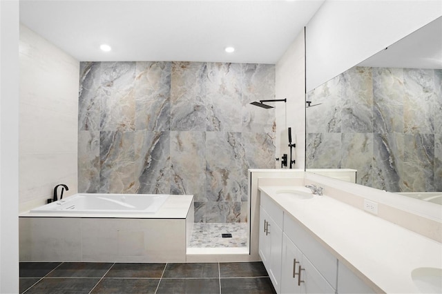 full bathroom with a garden tub, tile walls, double vanity, a sink, and walk in shower