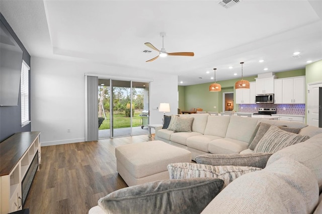 living room with recessed lighting, visible vents, ceiling fan, wood finished floors, and baseboards