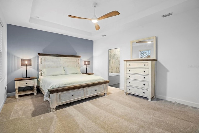 bedroom with carpet, a raised ceiling, visible vents, a ceiling fan, and baseboards