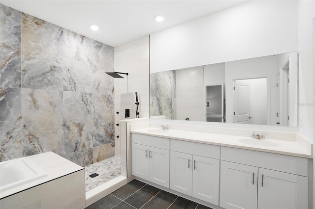 bathroom with tile patterned floors, double vanity, a sink, and a walk in shower