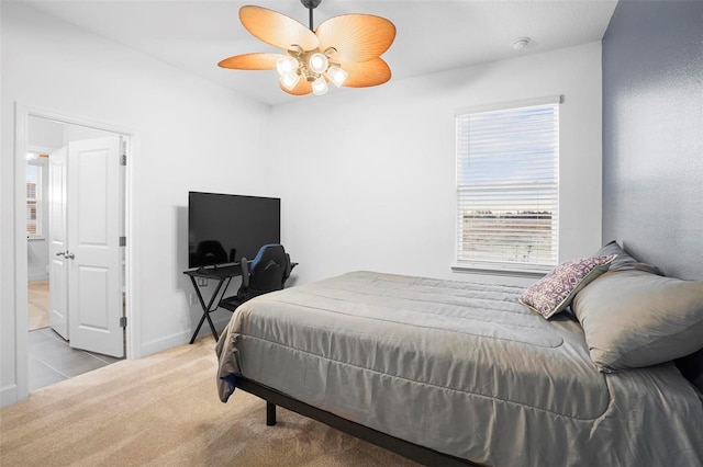 bedroom featuring light carpet, ceiling fan, and baseboards