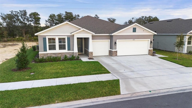 view of front of house featuring a garage, stone siding, concrete driveway, and a front yard