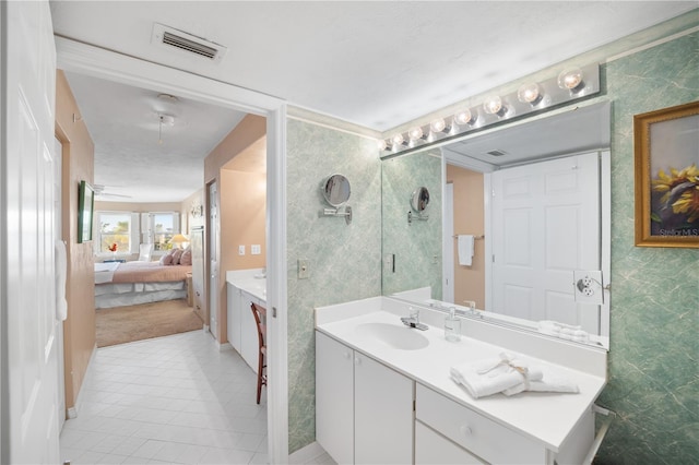 bathroom with a shower, vanity, and tile patterned floors