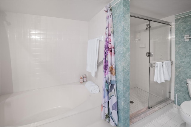 bathroom with toilet, tile patterned flooring, and separate shower and tub