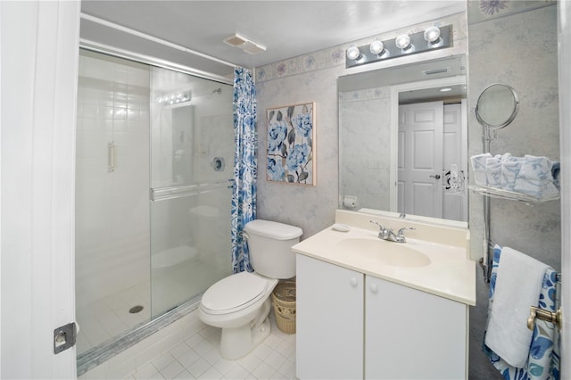 bathroom with toilet, vanity, tile patterned flooring, and a shower with door