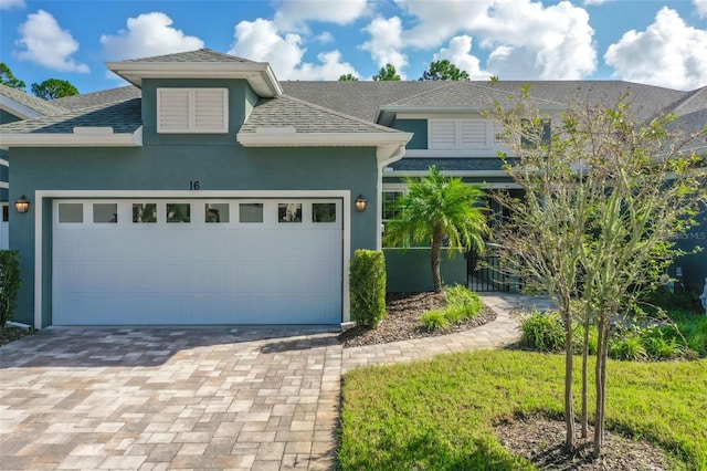 view of front of property with a front yard and a garage