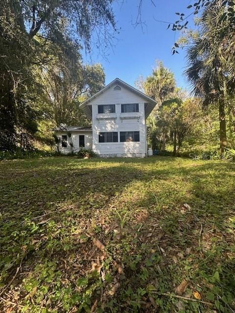 rear view of house with a lawn