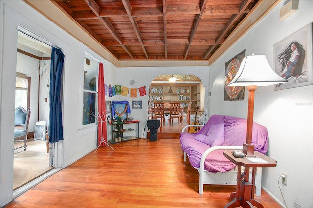 sitting room with wood ceiling, beam ceiling, and hardwood / wood-style flooring