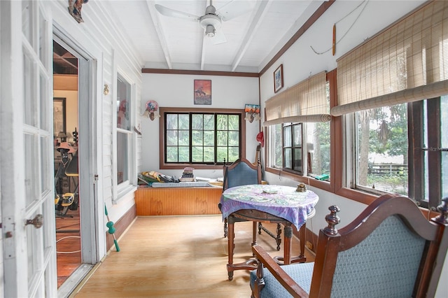 sunroom with beamed ceiling and ceiling fan