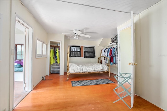 bedroom with a closet, wood-type flooring, and ceiling fan