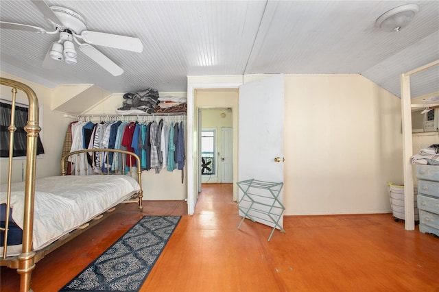 bedroom featuring vaulted ceiling, wood-type flooring, a closet, and ceiling fan