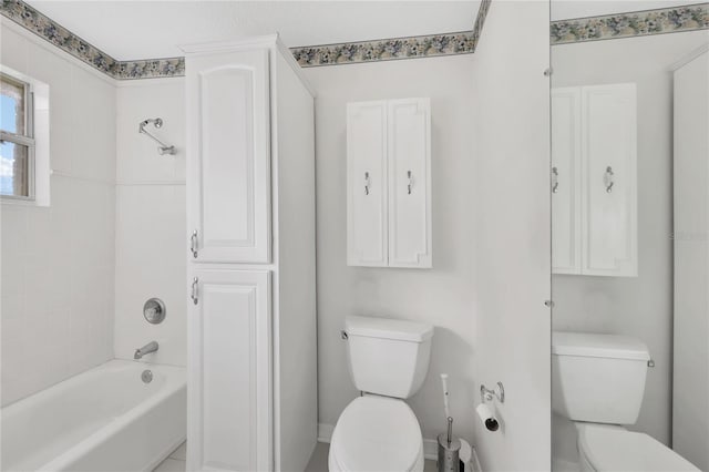 bathroom featuring tiled shower / bath and toilet