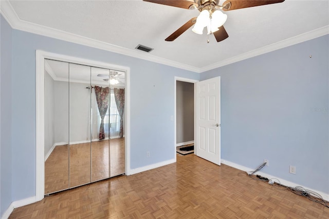 unfurnished bedroom with a closet, ornamental molding, light parquet floors, a textured ceiling, and ceiling fan