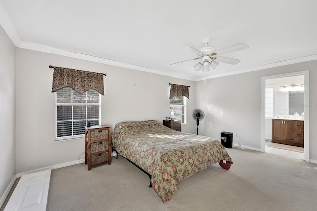 carpeted bedroom featuring ceiling fan, ornamental molding, and ensuite bathroom