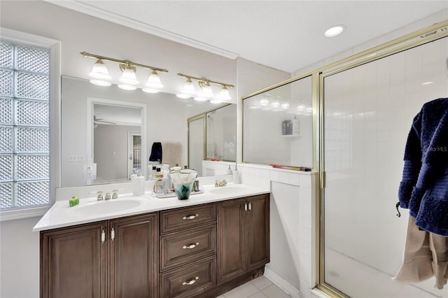 bathroom featuring vanity, walk in shower, tile patterned floors, and a wealth of natural light