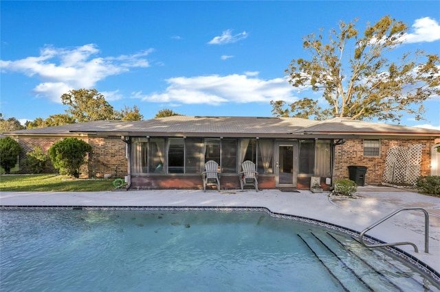 back of house with a patio area and a sunroom