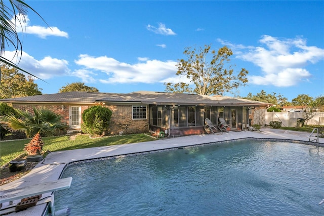 view of pool featuring a patio and a sunroom