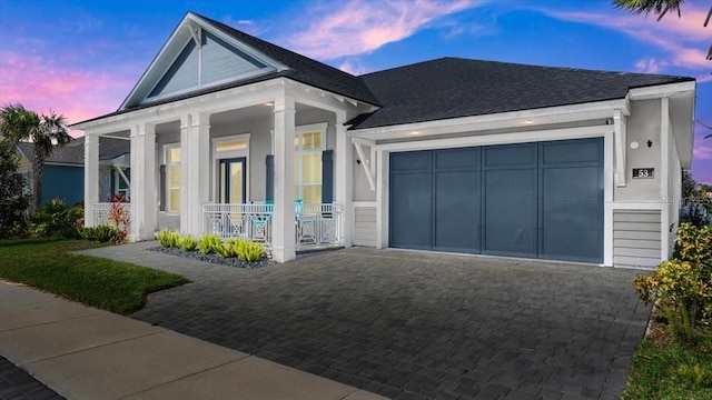 view of front facade featuring a garage and a porch