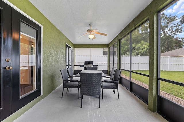 sunroom featuring ceiling fan