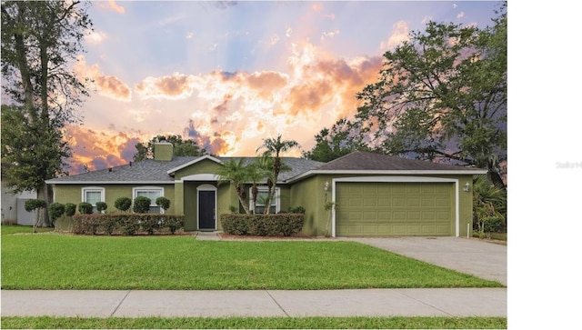 ranch-style home featuring a yard and a garage