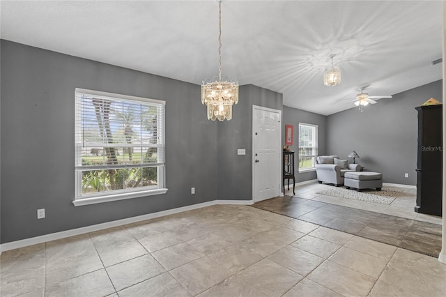 foyer entrance with ceiling fan with notable chandelier and light tile patterned floors