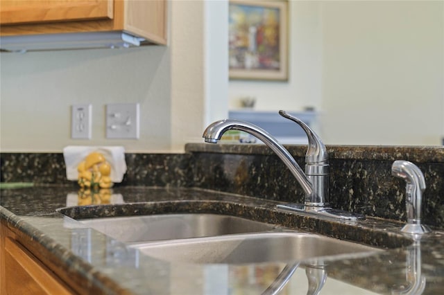 room details with sink and dark stone counters