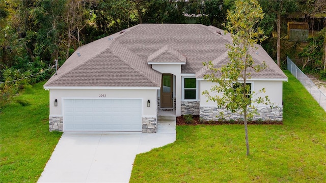 view of front of home with a front yard and a garage