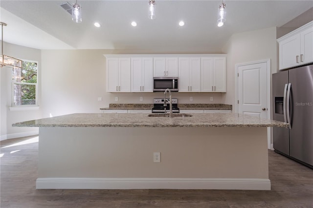 kitchen with an island with sink, white cabinetry, decorative light fixtures, and appliances with stainless steel finishes