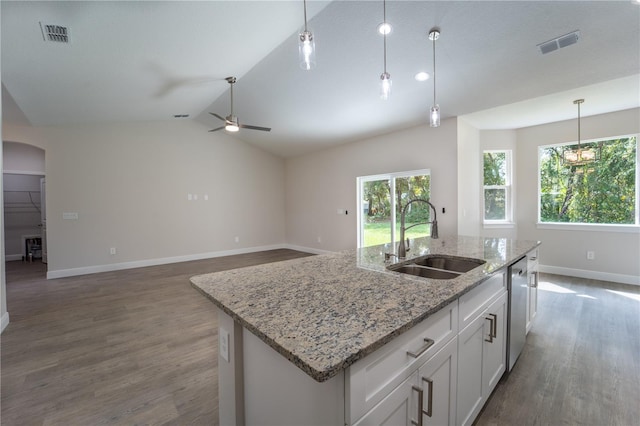 kitchen featuring vaulted ceiling, sink, stainless steel dishwasher, dark hardwood / wood-style floors, and white cabinetry