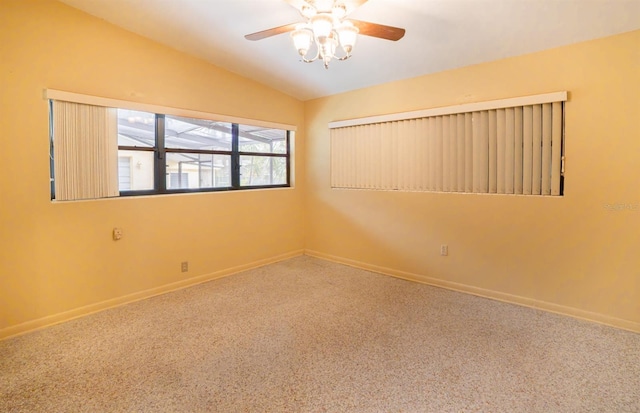 spare room featuring ceiling fan, carpet, and vaulted ceiling