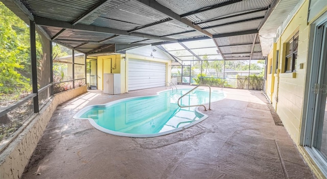 view of pool with a patio area, a lanai, and an outdoor structure