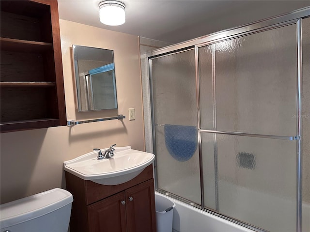 full bathroom with vanity, toilet, and enclosed tub / shower combo