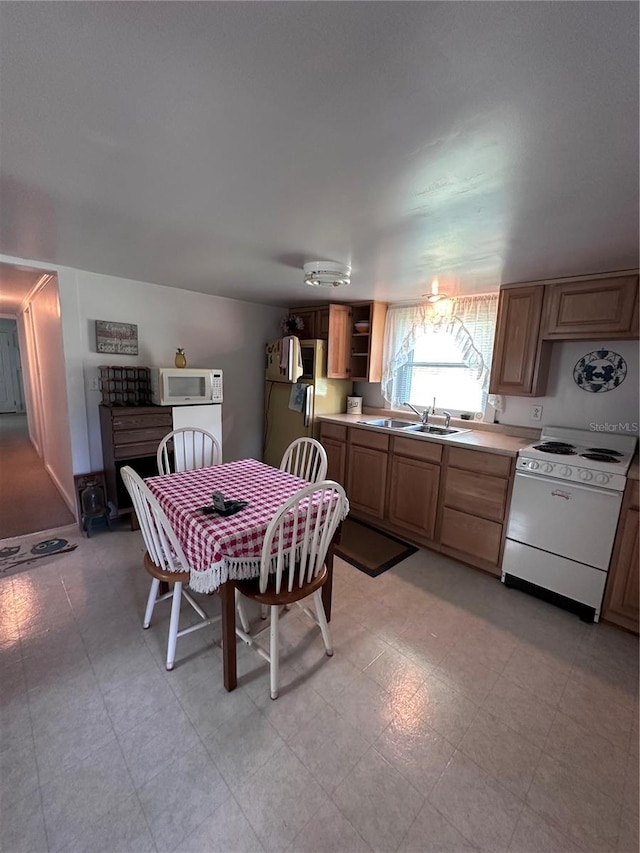 kitchen featuring sink and white appliances