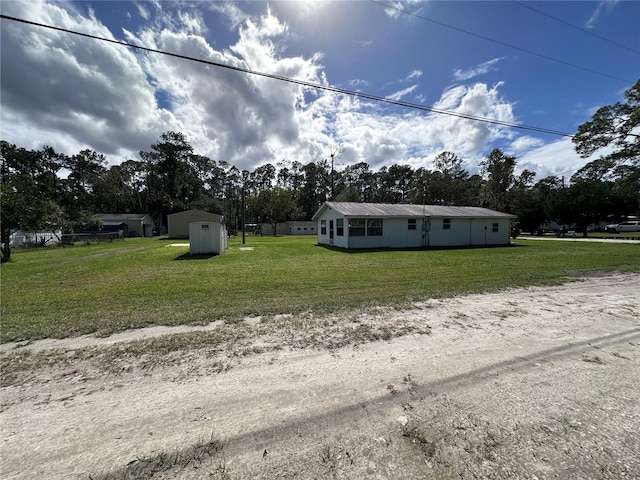 view of front facade with a storage unit and a front lawn