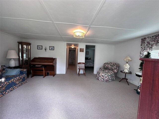 living area featuring baseboards and carpet flooring